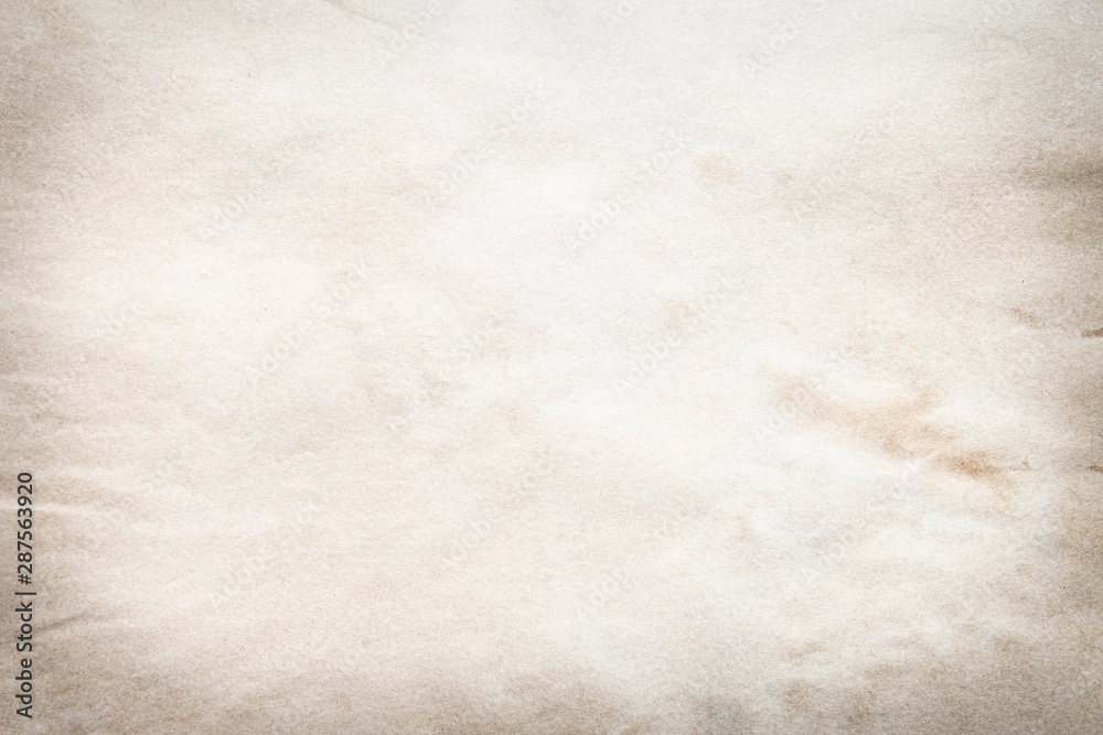 Naklejka premium Old brown and white paper stained with coffee. Vintage abstract background.