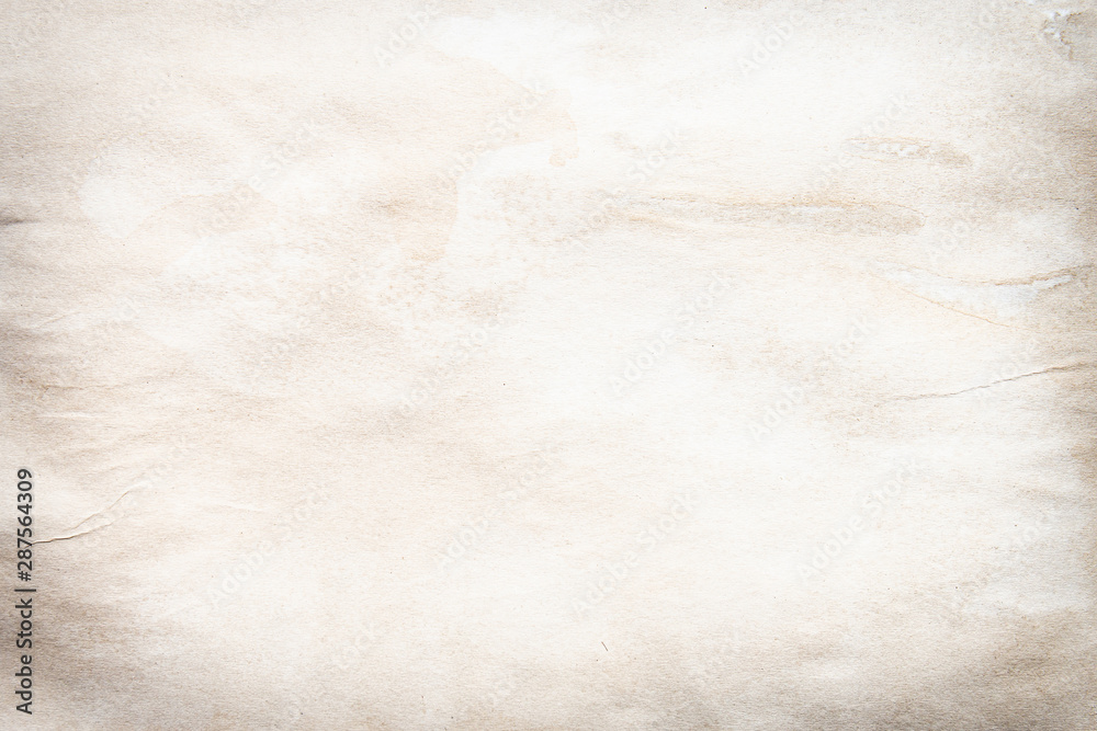 Naklejka premium Old brown and white paper stained with coffee. Vintage abstract background.