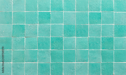 Old retro azure green ceramic tile texture background. Azure green square tiled wall.