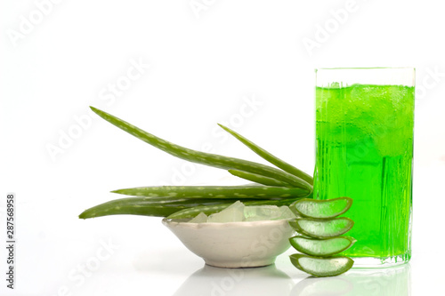 fresh aloe vera leaves with slices gel in wooden spoon and juice isolated on white background. aloe vera popular medicinal used for beauty and health