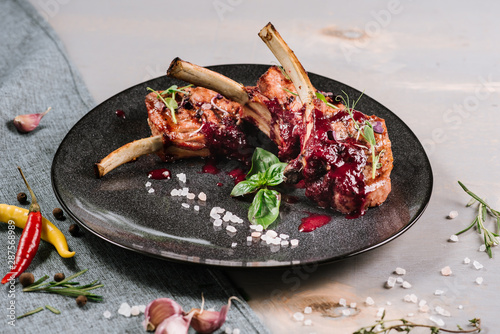 Grilled ribs with red sauce on the wooden background