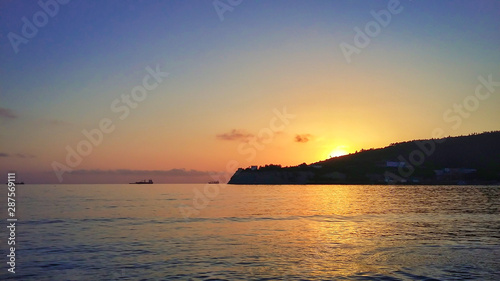 Sunset at sea  ships far into the sea.