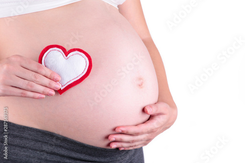 Wallpaper Mural Pregnant women holding heart symbol placed on belly isolated on white background Torontodigital.ca