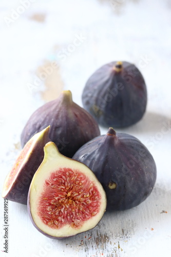 Fig fruit on a white woode nbackground photo