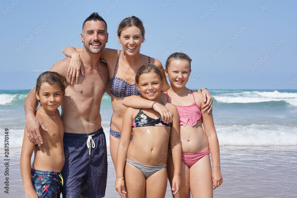 Family standing on the beach, summer vacation Family standing on the beach, summer vacation