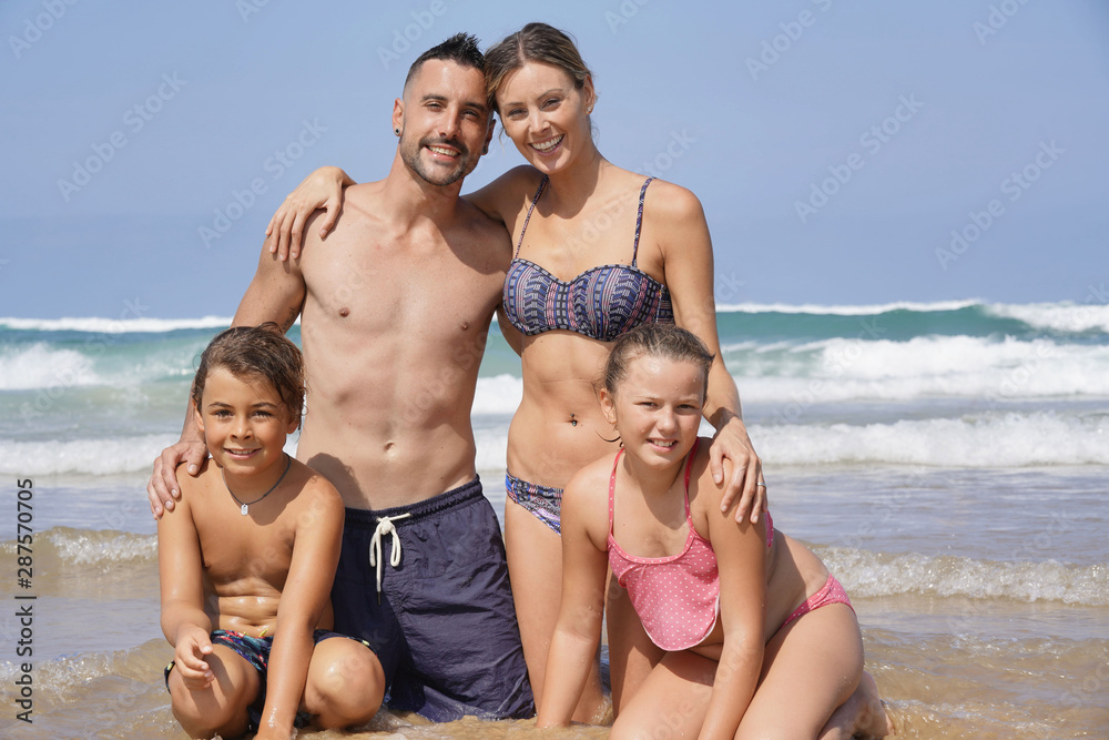Family standing on the beach, summer vacation Family standing on the beach, summer vacation
