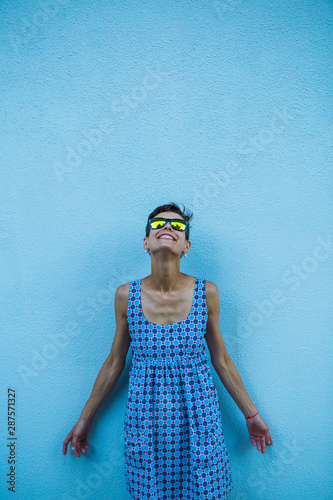 Woman against a blue wall. © zhukovvvlad