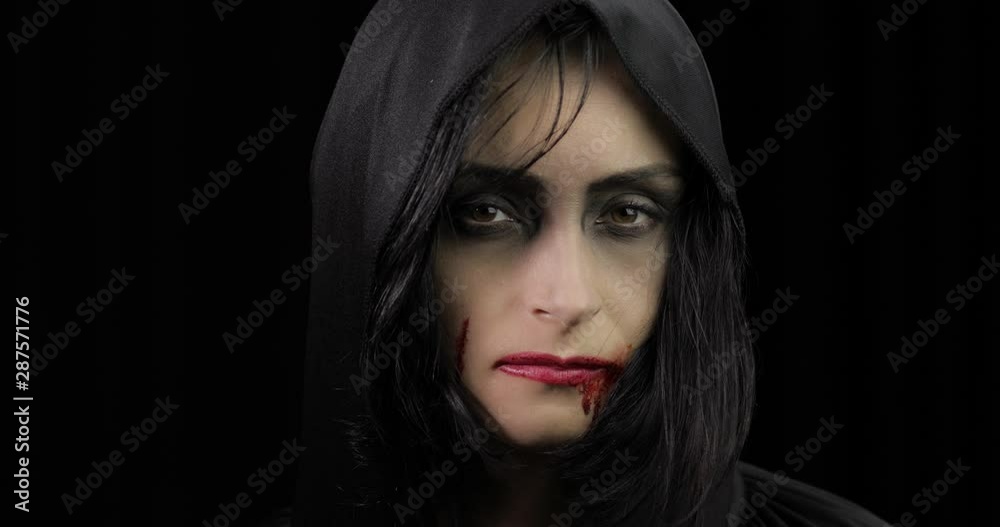 Vampire Halloween makeup. Woman portrait with blood on her face. Vampire Halloween makeup. Woman portrait with blood on her face.