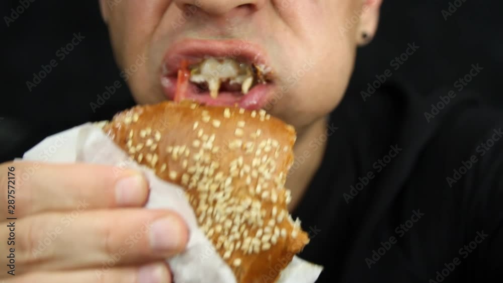 Man eating big burger. Hungry man eating big hamburger Man eating big burger. Hungry man eating big hamburger