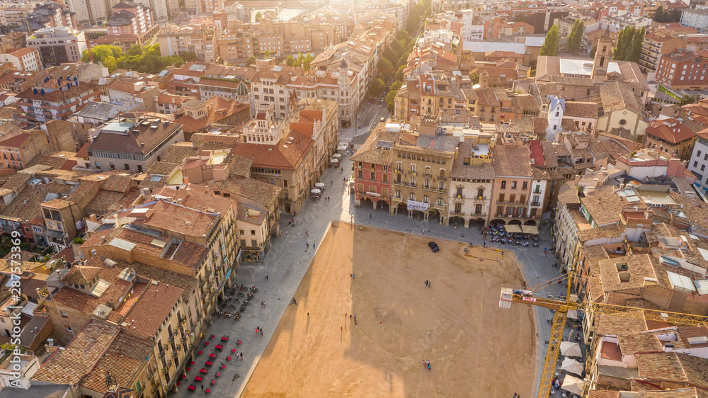 Spain small city Vic. Catalan main square. Aerial photo. Warm colors. Golden hour sunset light