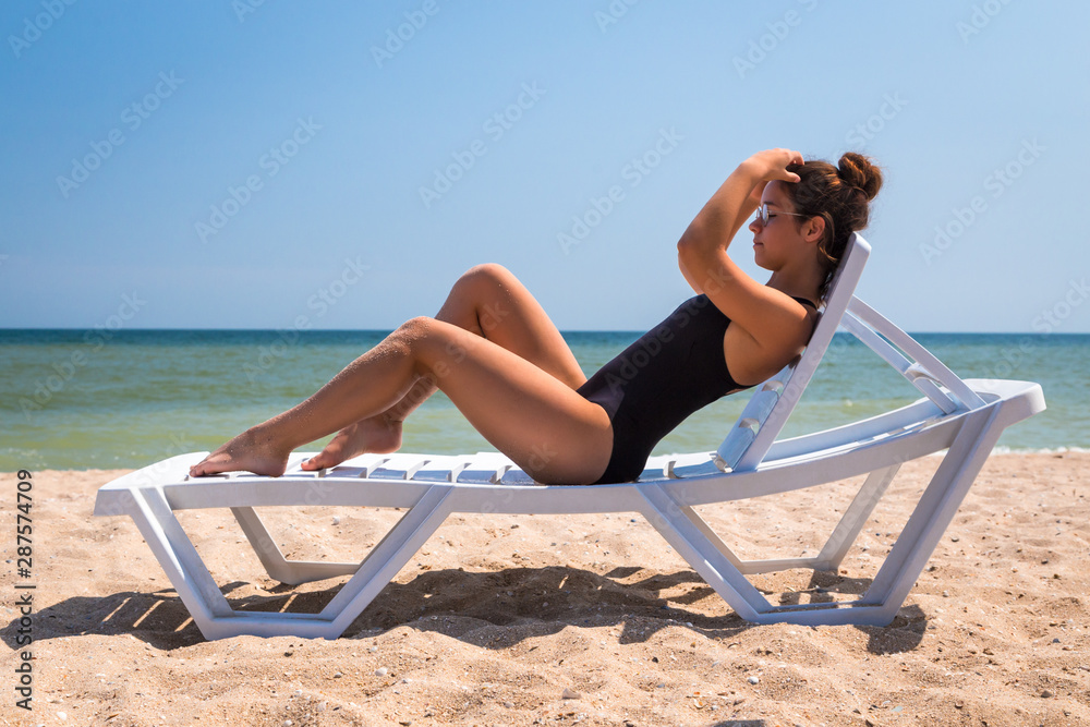 Beautiful girl lying on the beach chair Stock Photo | Adobe Stock
