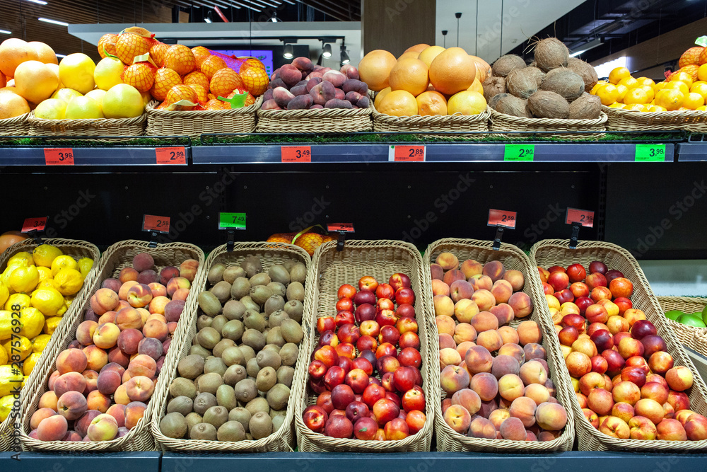 Supermarket fruit zone. A variety of fruits on shelves of store.
