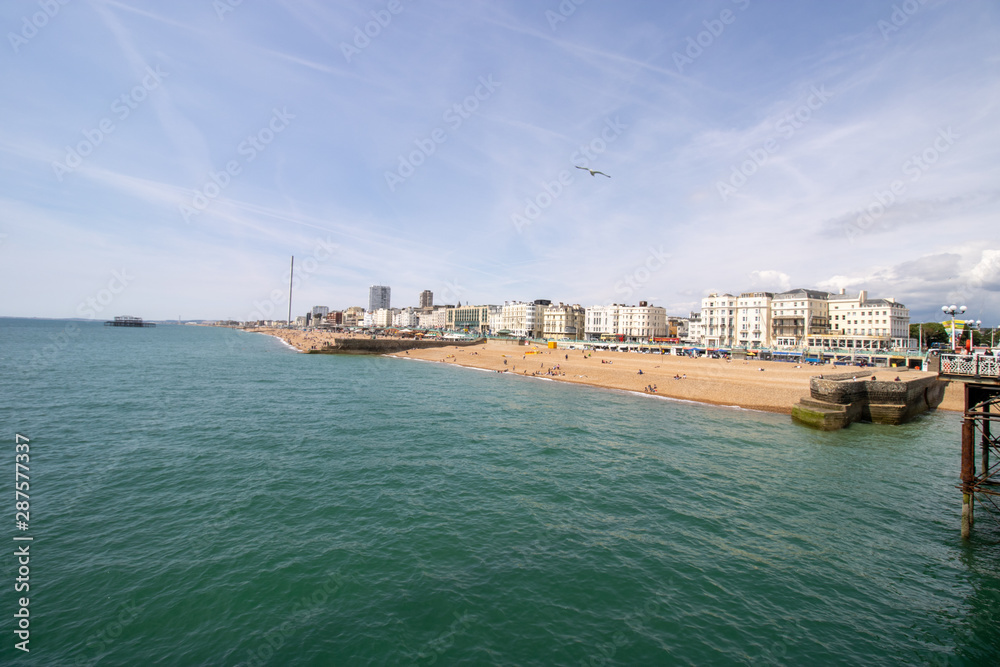 Brighton UK, 10th July 2019: The famous beautiful Brighton Beach and Seafront showing the coastline area on a bright sunny day,