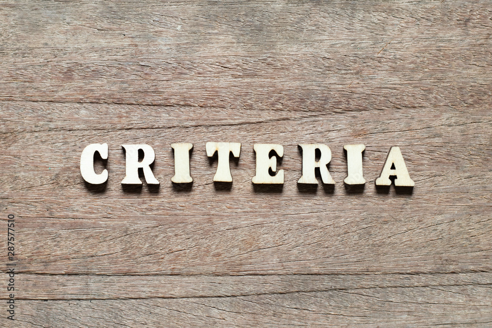 Letter block in word criteria on wood background Letter block in word criteria on wood background