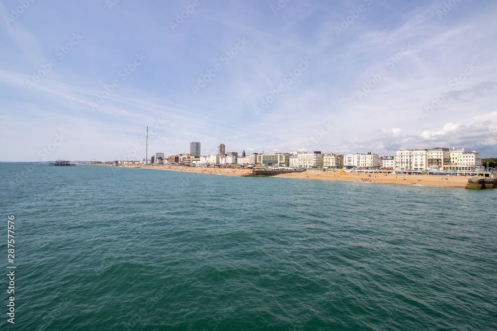 Brighton UK, 10th July 2019: The famous beautiful Brighton Beach and Seafront showing the coastline area on a bright sunny day,