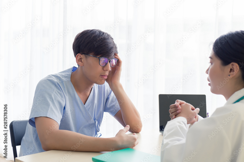 Young Asian patient men talking with the doctor in the hospital, health care and medical. Young Asian patient men talking with the doctor in the hospital, health care and medical.