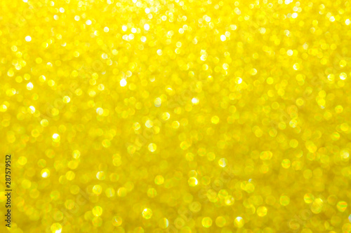 gold bright festive background for Christmas. gold glitter sparkles ray lights bokeh background With Blinking light.can be used for background or wallpaper.