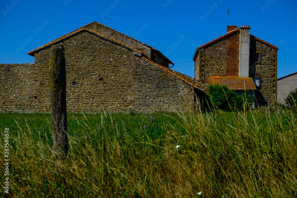 French farming village buildings with blue sky