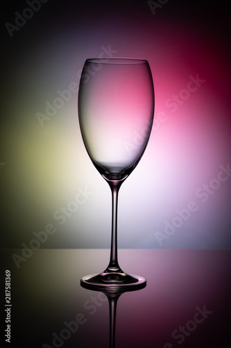 Empty wine glass goblets on a colored background abstract