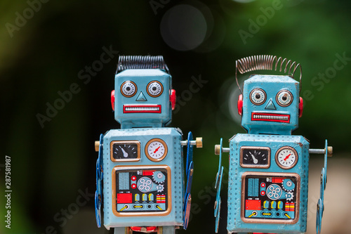 Vintage robot tin toy on yello background
