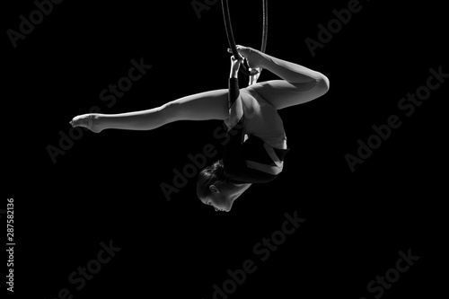 A female gymnast performing exercises on an air ring (hoop)