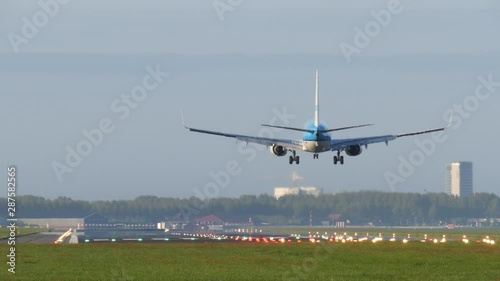 Passenger airplane landing at Schiphol airport photo