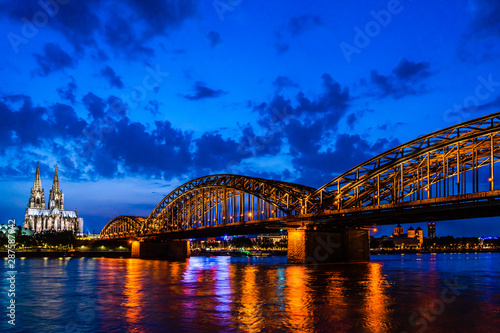Beautiful night landscape of the Cologne, Germany with gothic cathedral, Hohenzollern Bridge and reflections over the River Rhine