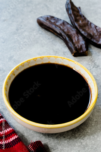 Carob Molasses and Pods Copy Space. photo