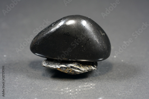 A black rock also called healing stone shungite, which consists mainly of carbon was photographed here in top quality. photo