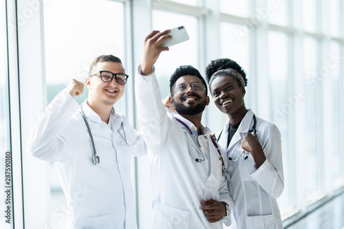 Group of doctors taking selfies in the lobby of the hospital