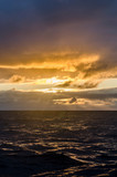 Dramatic sunset at sea after storm