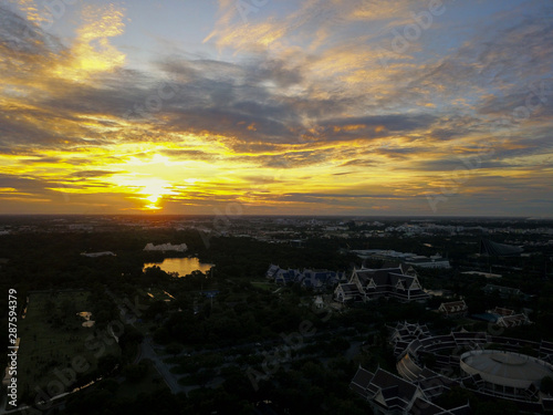 Beautiful sunset sky above the city with sky blue and orange light of the sun through the clouds in the sky, Orange and red dramatic colors, Warm color - Image