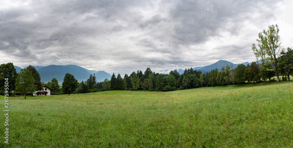 Panoramic landscape view of meadow in Austria. Before the rain