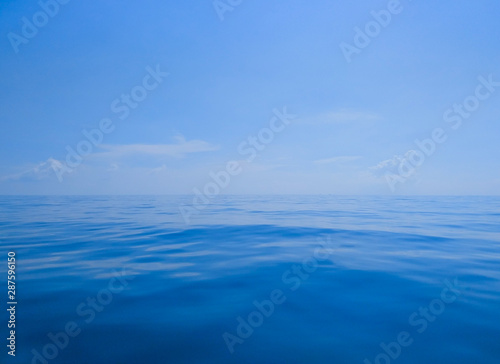 Deep blue sea and blue sky in the foggy day 