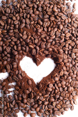 heart made of coffee beans and gronded coffe