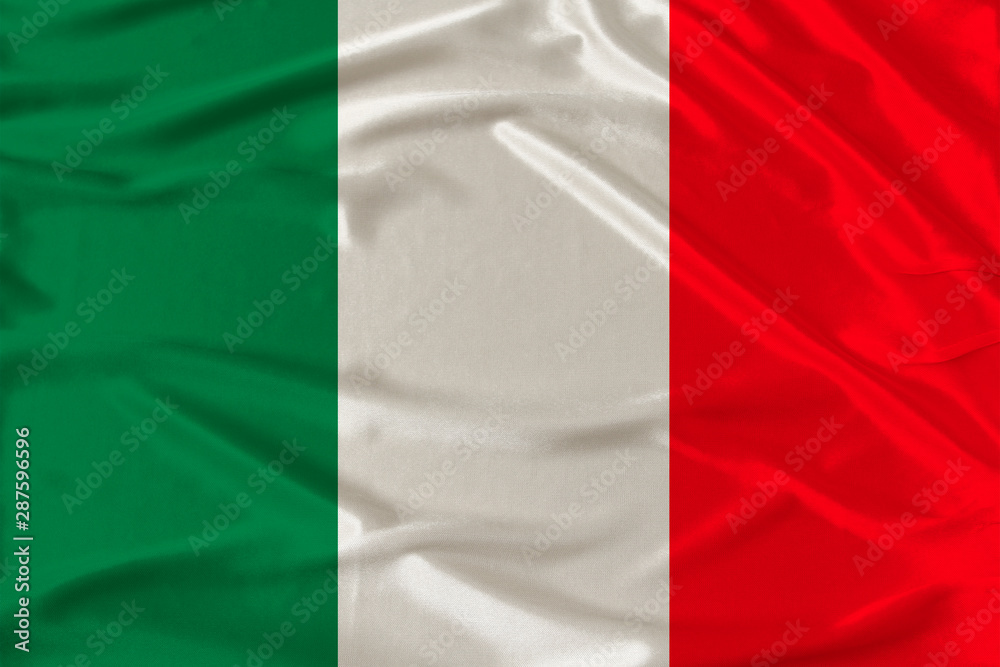 national flag of the country of Italy on gentle silk with wind folds, travel concept, immigration, politics, copy space, close-up