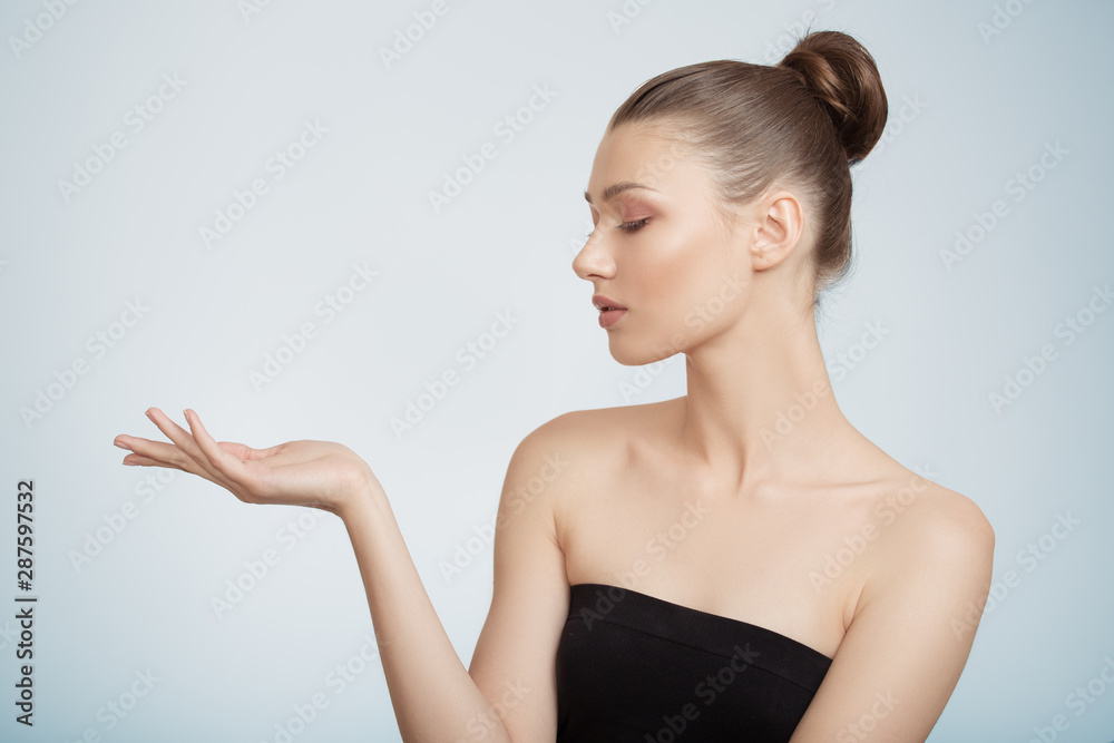 woman holds out her hand. Clean skin concept. blue background woman holds out her hand. Clean skin concept. blue background