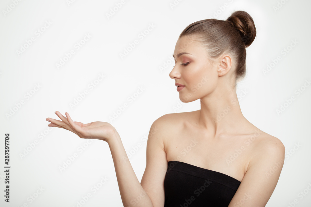 woman holds out her hand. Clean skin concept. Gray background woman holds out her hand. Clean skin concept. Gray background