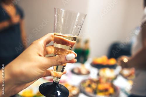 Celebration. Female hand with a glass of champagne