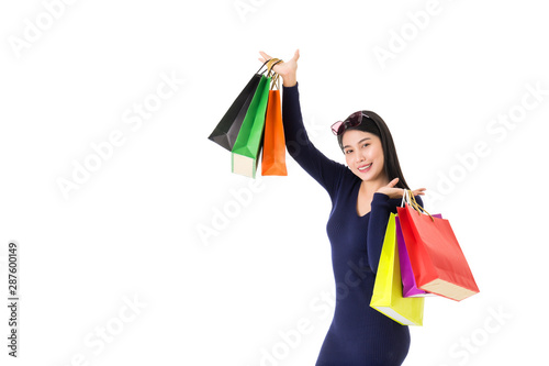 Young happy Asian woman holding shopping bags with smiley face isolated on white.