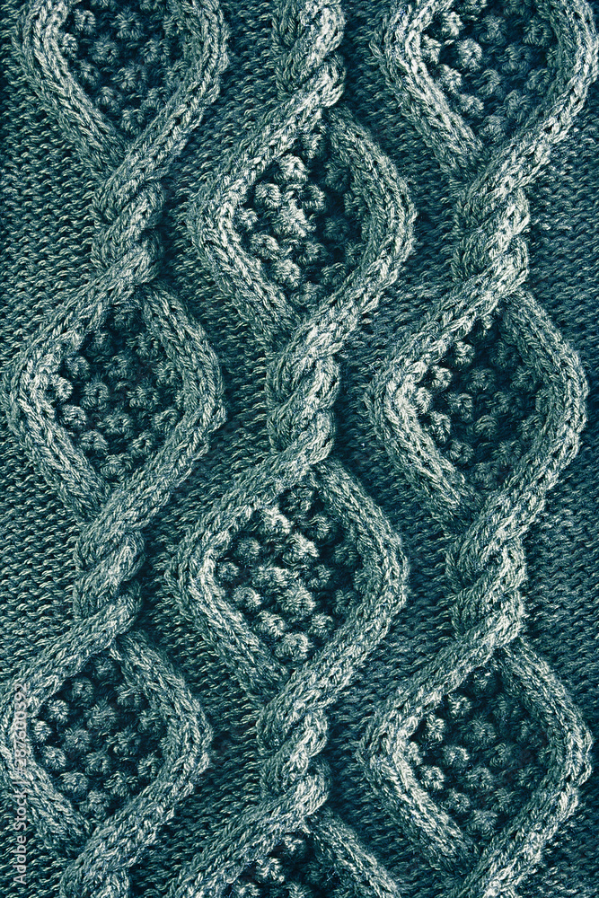 vertical background texture knitted canvas with aran patterns close up in turquoise color vertical background texture knitted canvas with aran patterns close up in turquoise color