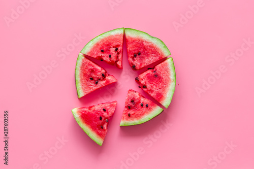 Cut watermelon for break with fruit on pink background top view