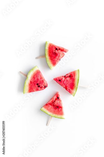 Slices of watermelon popsicle on white background top view