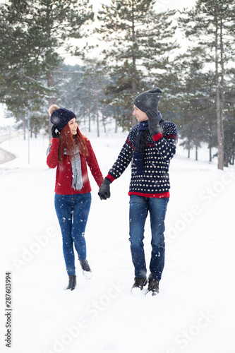 young girl and her boyfriend enjoying the snow