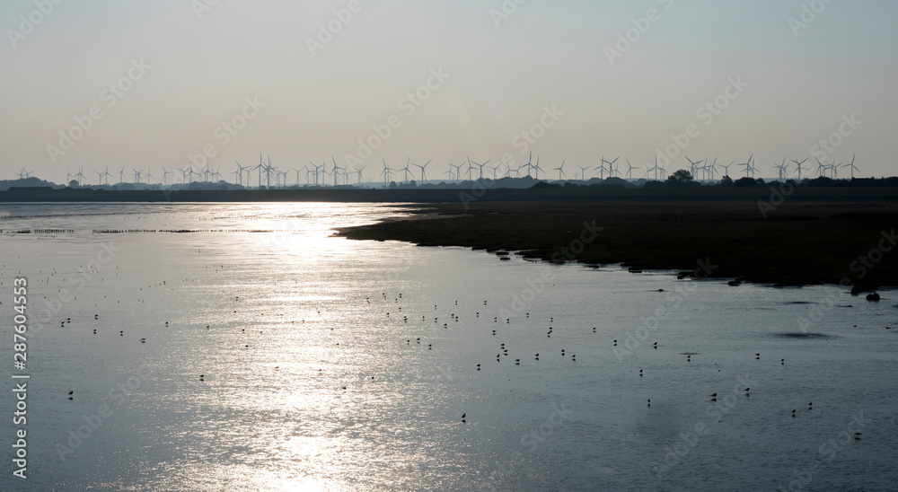 silhouette of wind turbine park on the coast of east frisia in lower saxomy germany