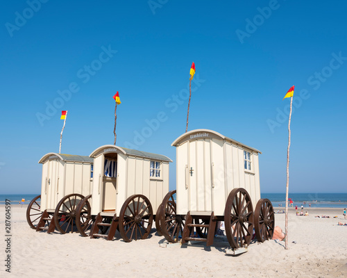 old fashioned bathing carts used for changing on sunny beach of german island norderney photo