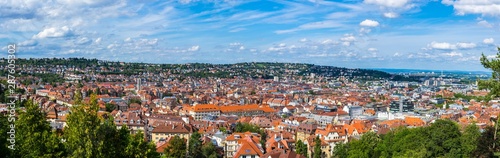 Germany, XXL panorama of city stuttgart downtown houses and church aerial view above the roofs with sun in summer