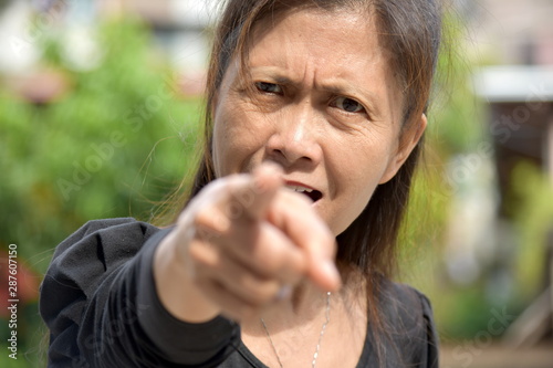 A Filipina Female Senior Pointing