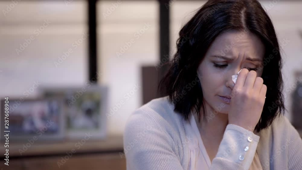 selective focus of crying woman wiping tears selective focus of crying woman wiping tears