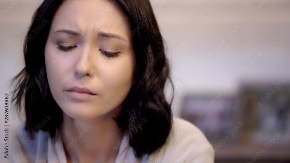 selective focus of crying woman wiping tears selective focus of crying woman wiping tears